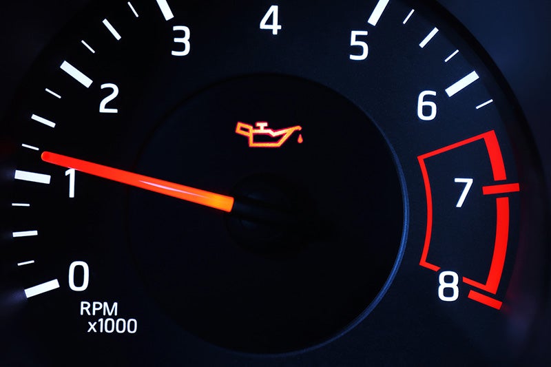 Oil warning light illuminated on a vehicle dashboard